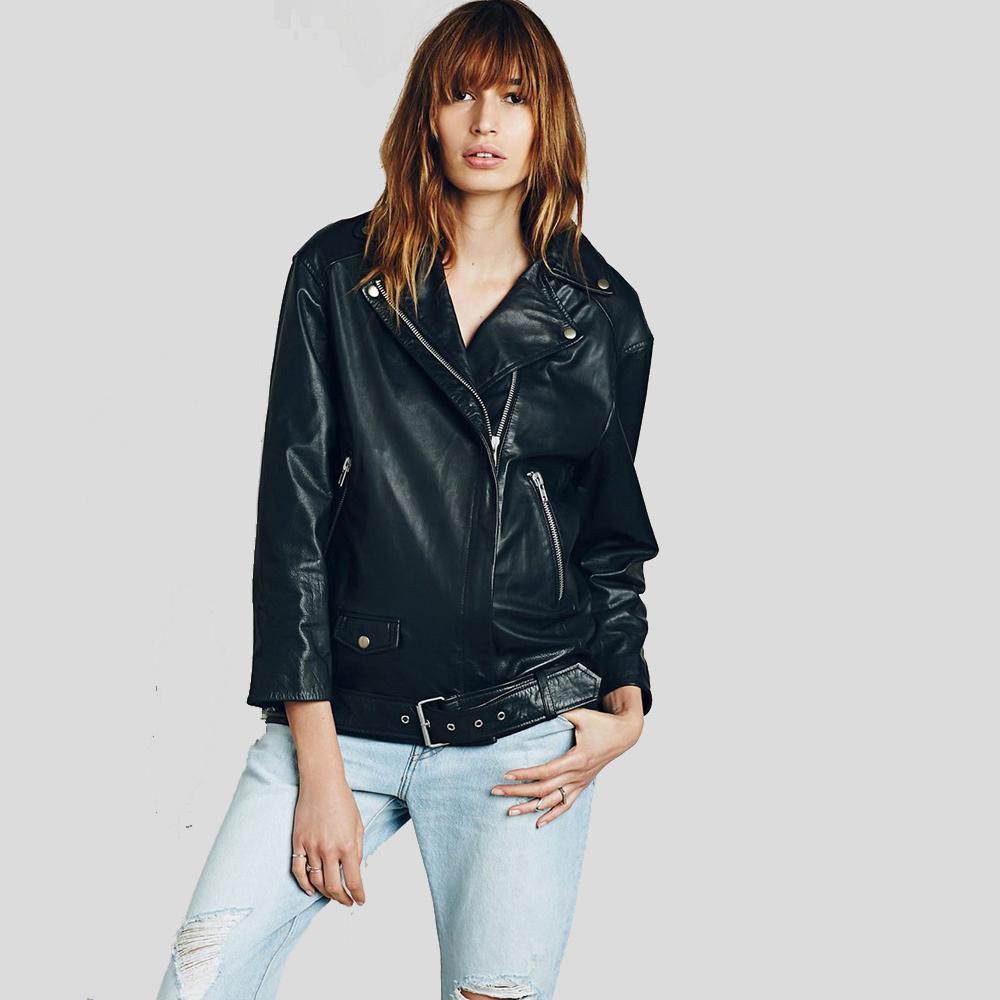 Woman wearing a black leather jacket and light blue jeans on a white background