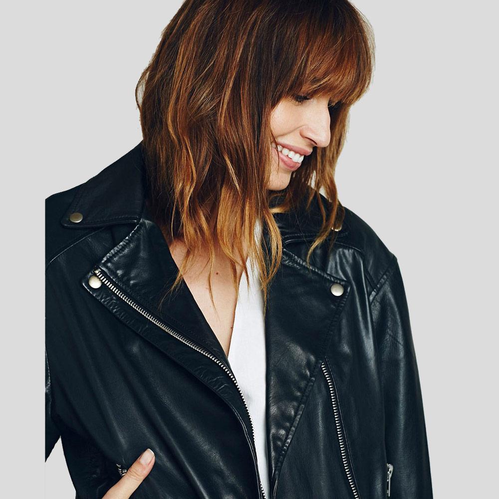 Woman wearing a black leather jacket on a plain background