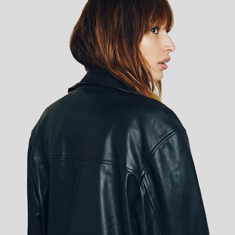 Person wearing a black leather jacket on a plain background
