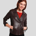 Woman wearing a brown leather jacket on a light gray background