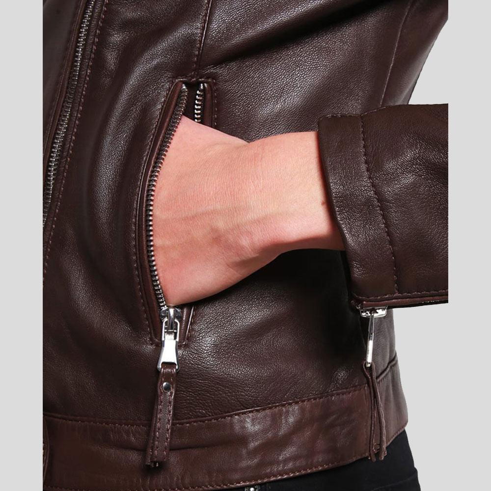 Brown leather jacket with a hand reaching into the pocket on a light gray background