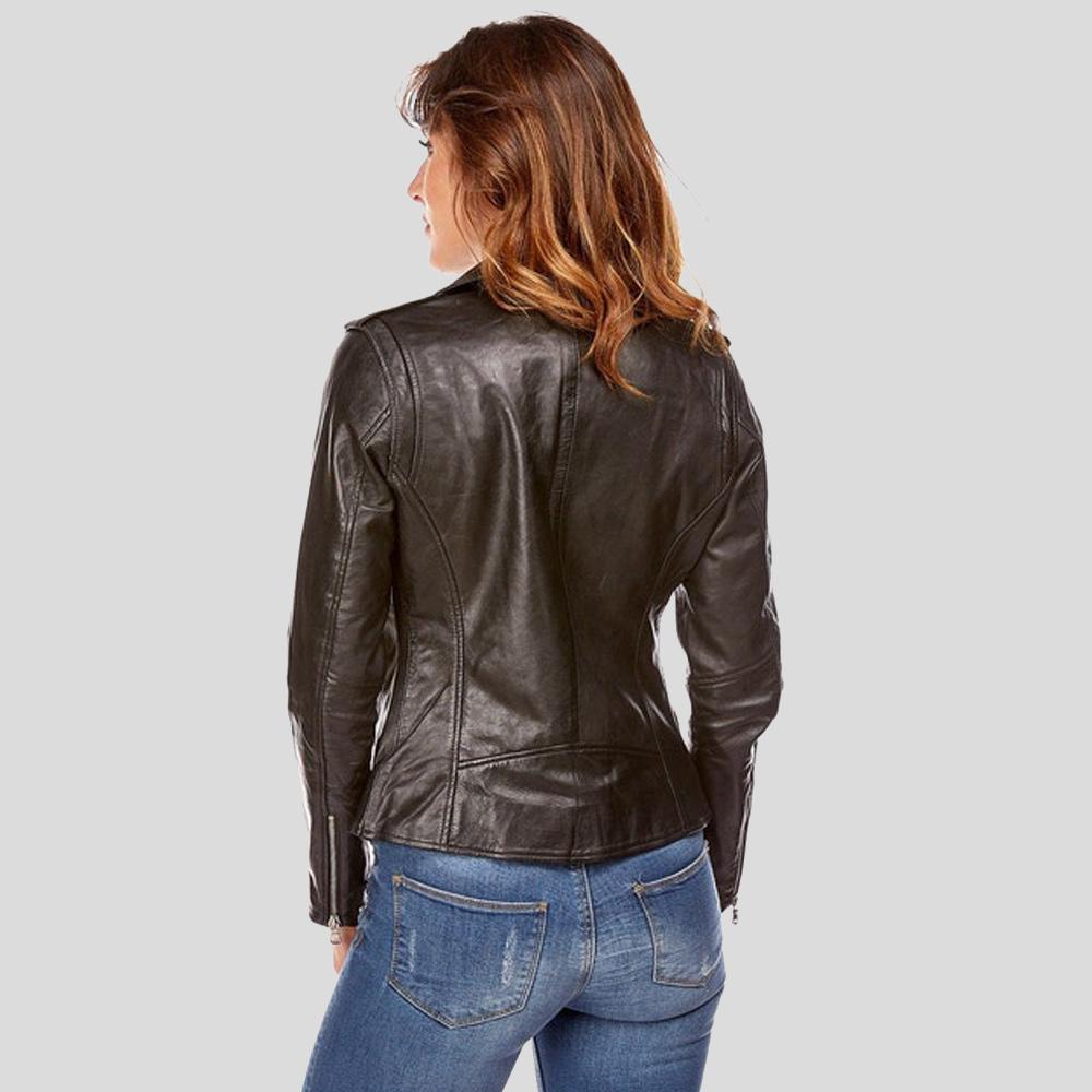 Woman wearing a black leather jacket and blue jeans on a gray background