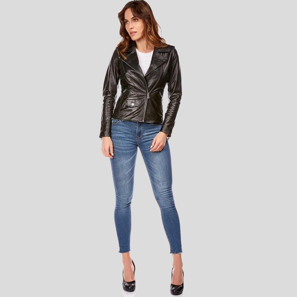 Woman wearing a black leather jacket and blue jeans on a gray background