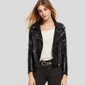Woman wearing a black leather jacket on a gray background