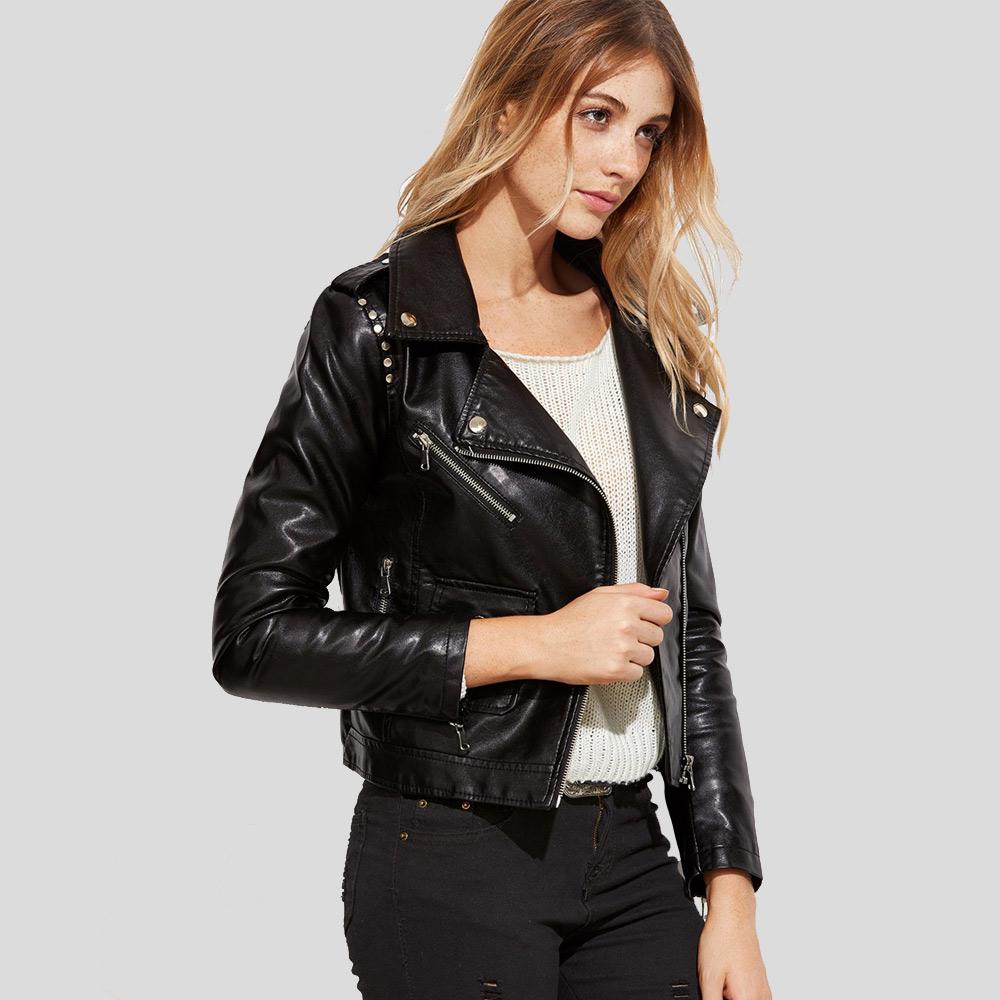 Woman wearing a black leather jacket on a light gray background