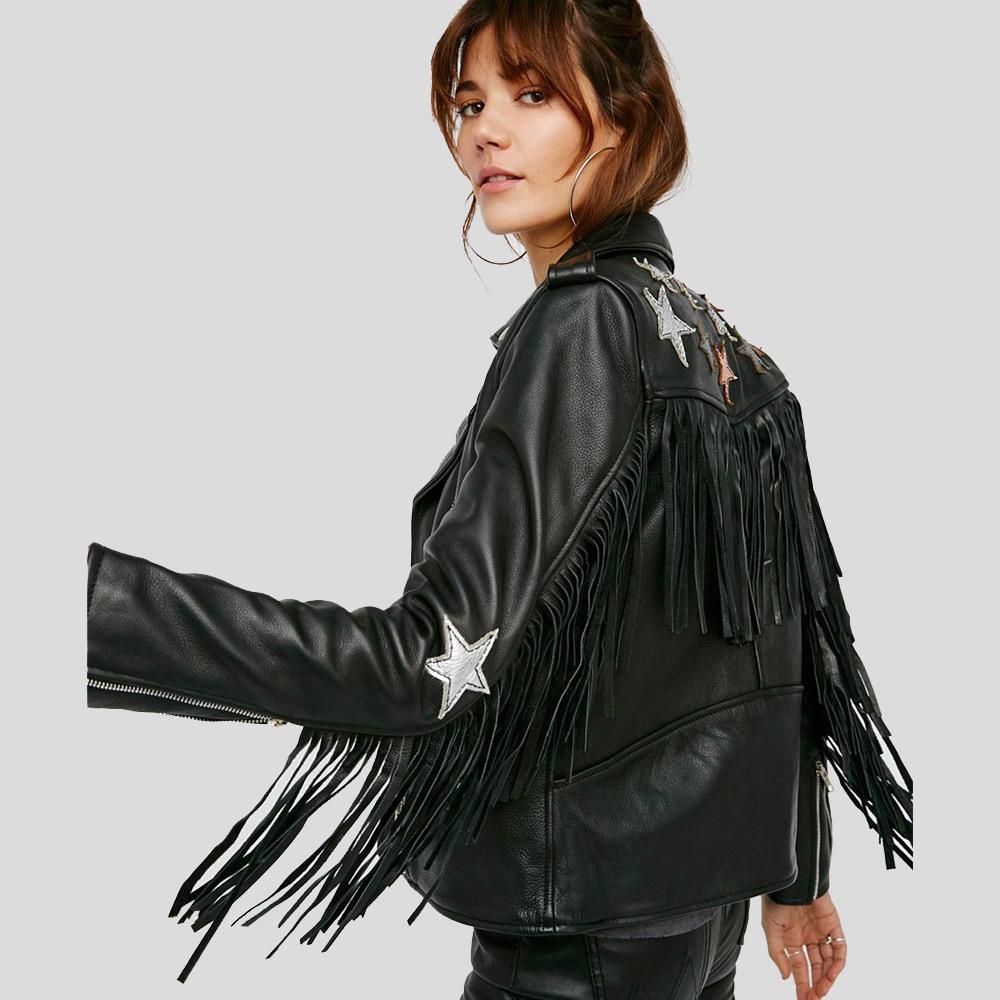 Black leather jacket with fringe and star embellishments on a plain background