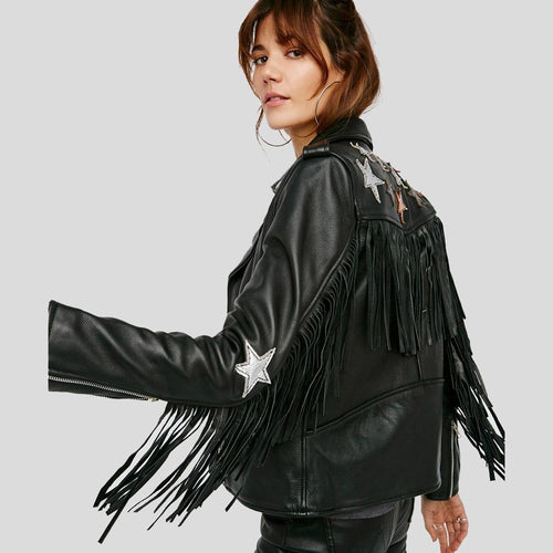 Black leather jacket with fringe and star embellishments on a plain background
