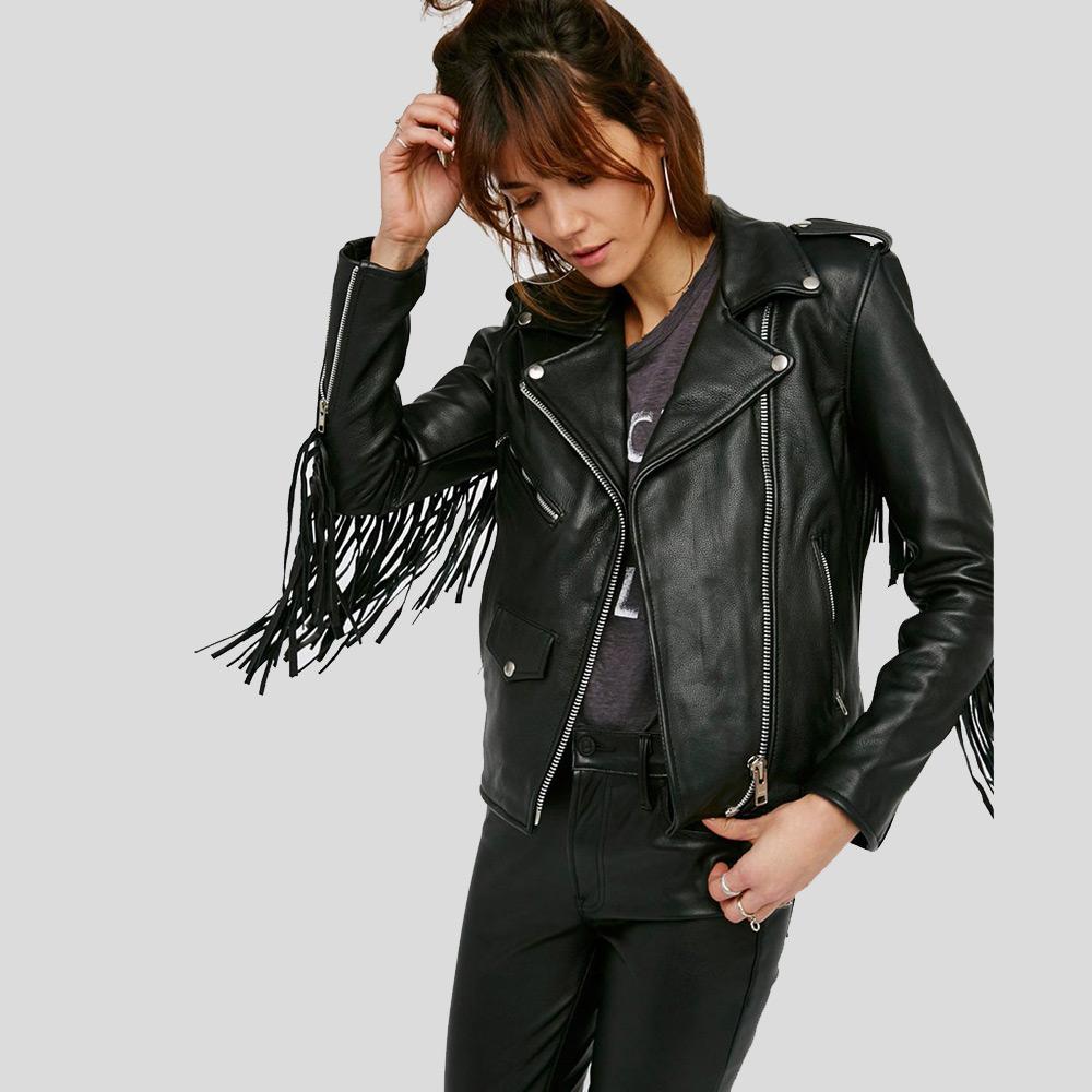 Woman wearing a black leather jacket with fringe details on a light gray background