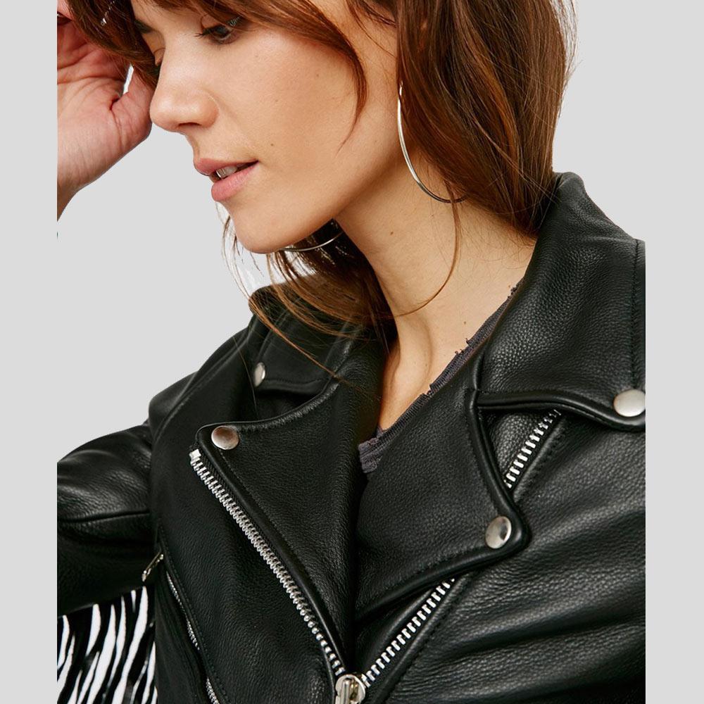 Close-up of a person wearing a black leather jacket with a neutral background