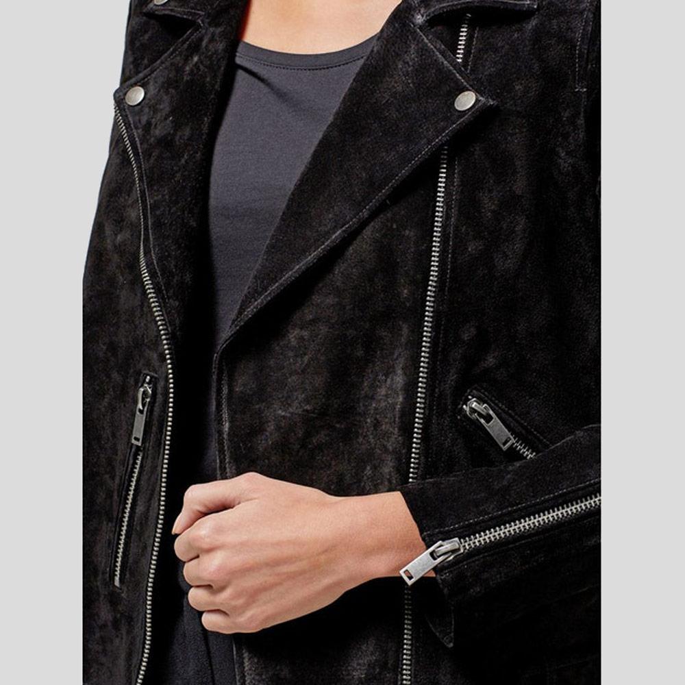 Black suede jacket with zippers on a plain background