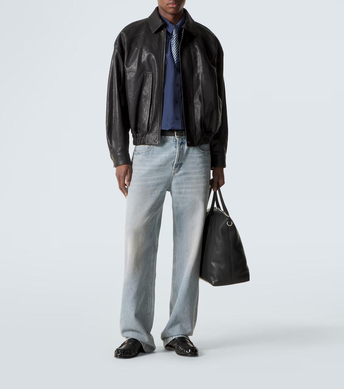 man standing wearing black bomber jacket