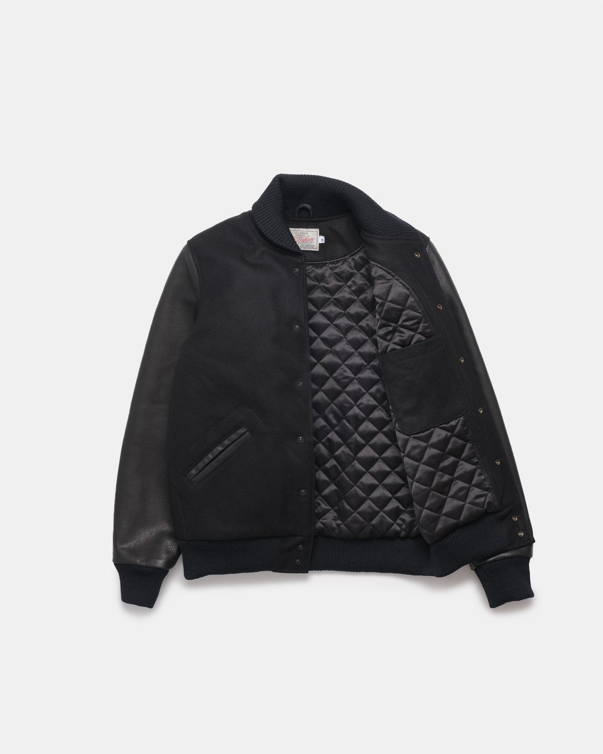Black quilted jacket on a light gray background