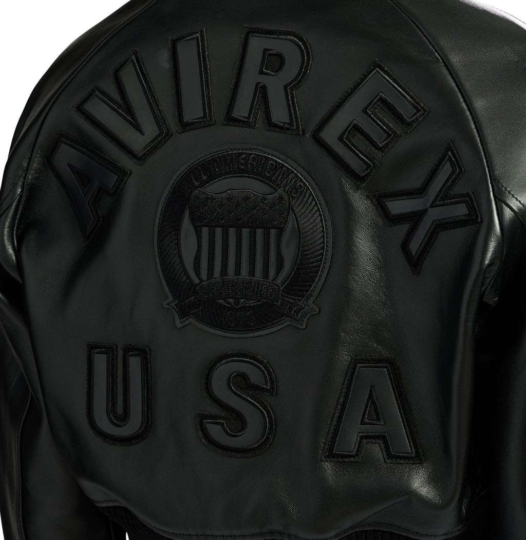 Close-up of black AVIREX and USA leather back lettering