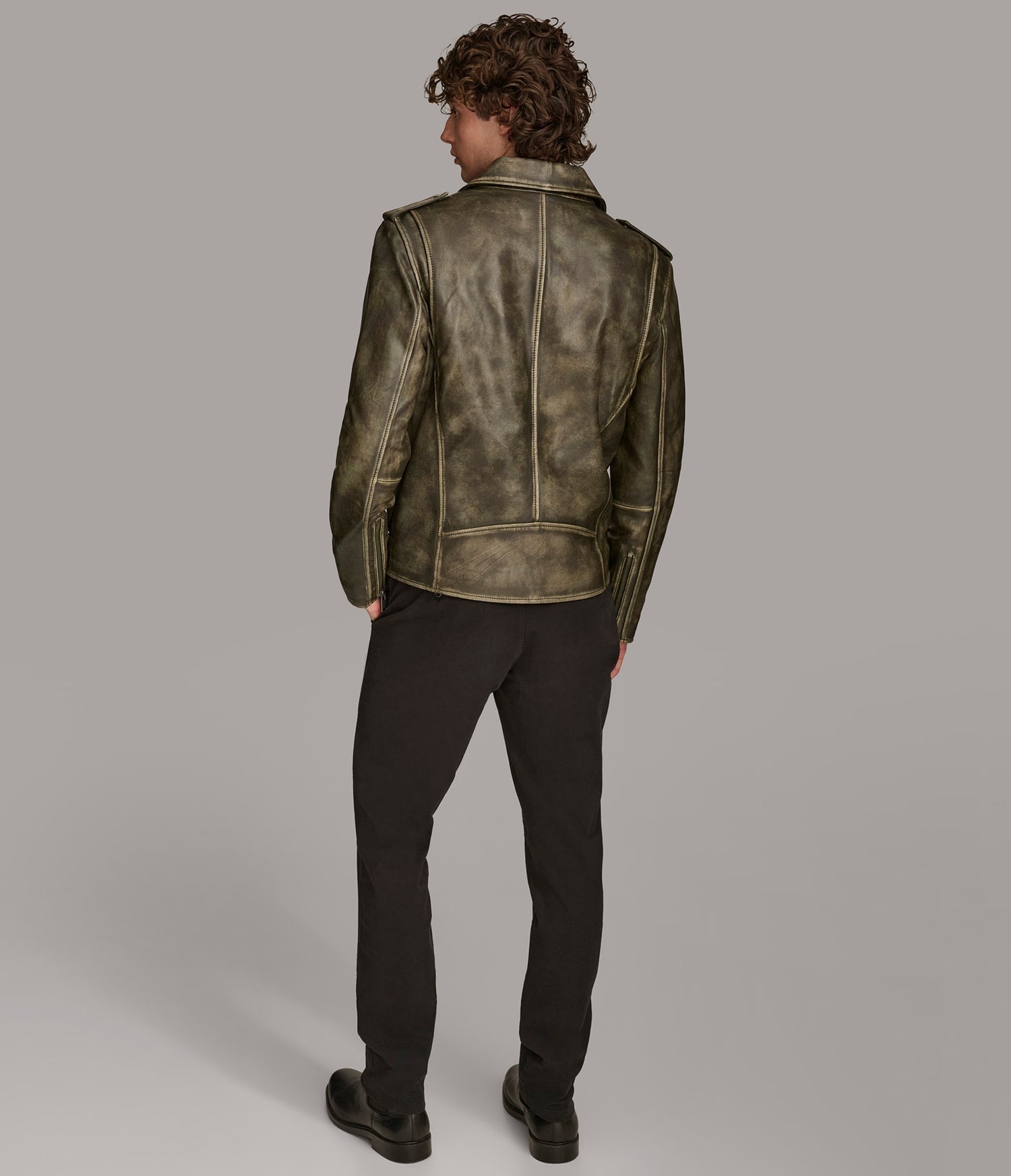 model wearing distressed leather jacket
