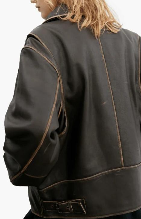 Close-up back view of a person wearing a dark brown leather jacket with contrast tan stitching and a belted waist, against a plain light background.