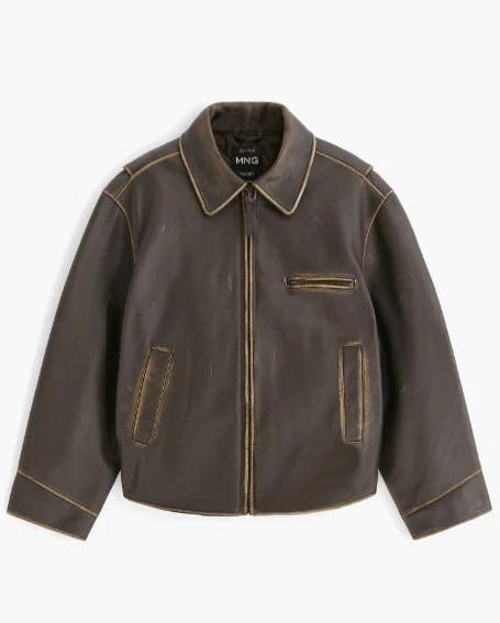 A dark brown leather jacket with tan contrast stitching, featuring a zippered front, pointed collar, and two vertical welt pockets, shown against a plain white background.