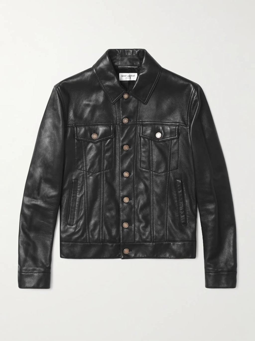 A black leather trucker jacket with a button-up front, chest flap pockets, and side pockets, displayed flat against a light gray background.