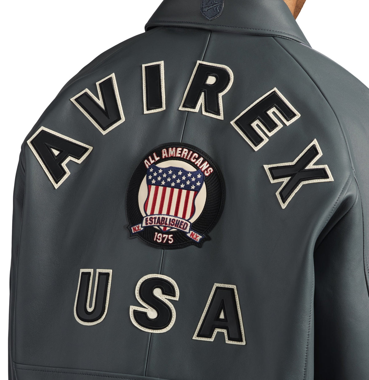 Close-up of AVIREX lettering and embroidered shield on jacket back