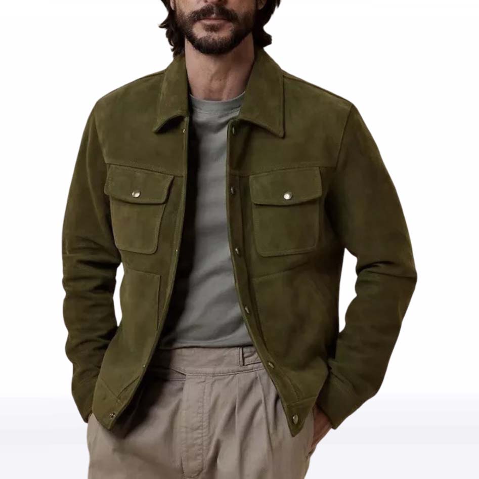 A man wearing an olive green suede jacket over a gray t-shirt and beige trousers, shown from the chin down against a plain white background.