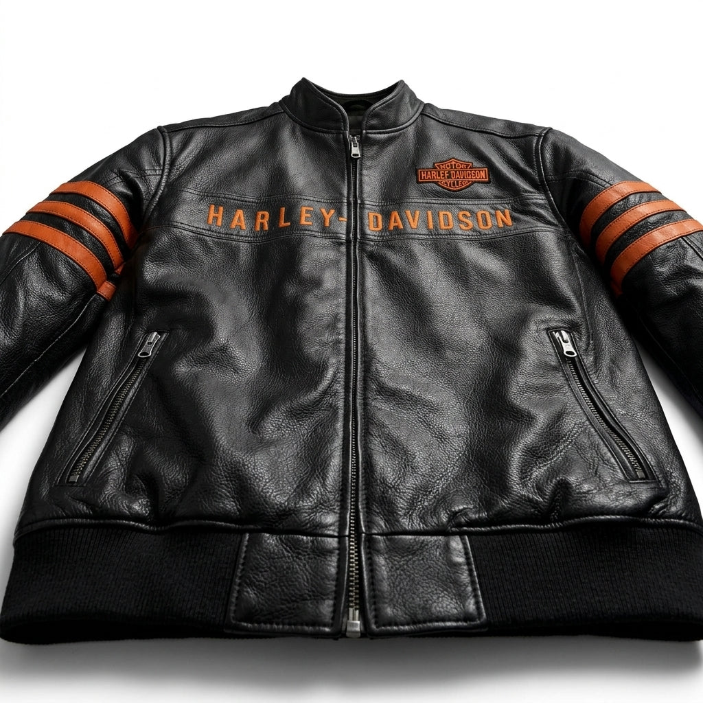 A black leather motorcycle jacket with orange and black striped sleeves, featuring 'HARLEY-DAVIDSON' text across the chest and a brand logo patch on the left chest, shown against a plain white background.