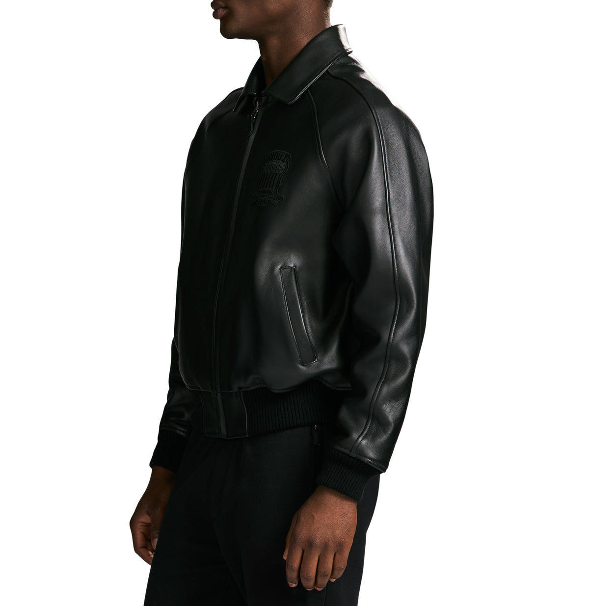 Black leather jacket worn by a person on a white background