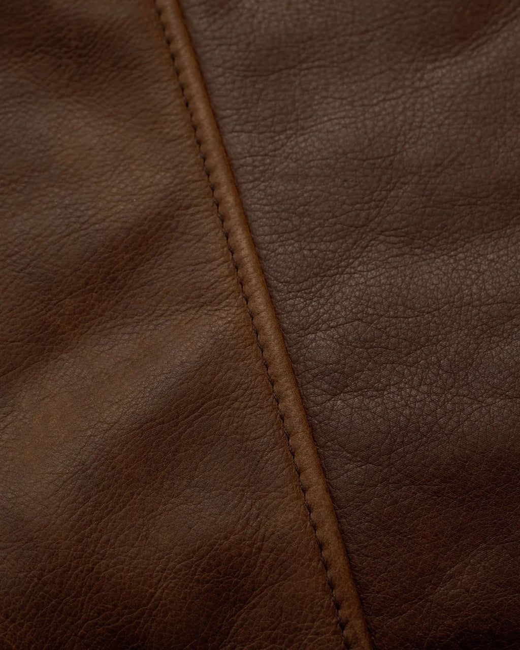 Close-up of brown leather with visible stitching