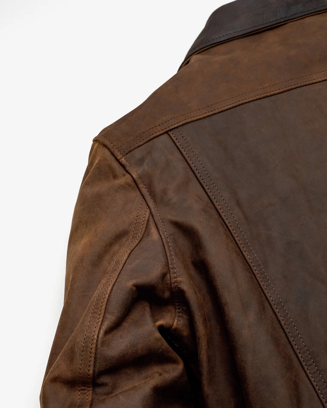 Close-up of a brown leather jacket on a white background