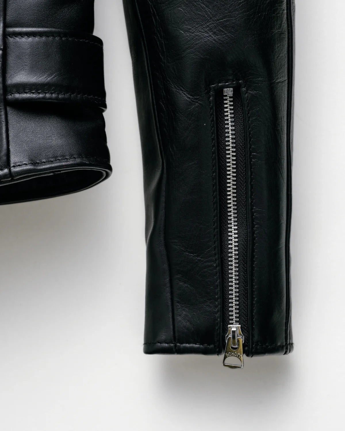 Black leather jacket with a zipper on a white background