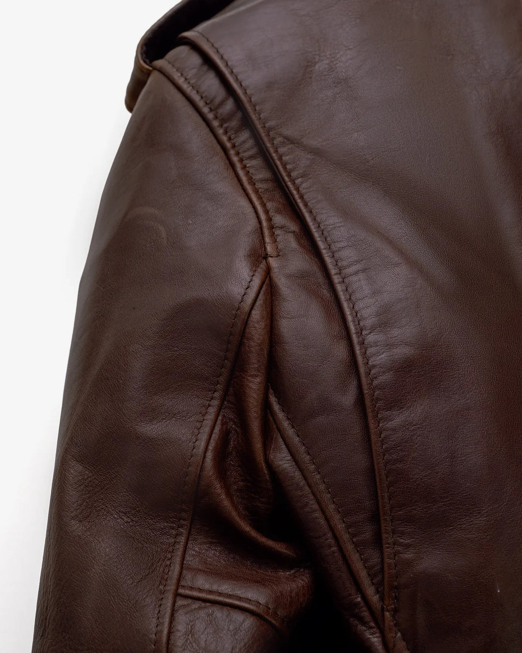 Close-up of a brown leather jacket on a white background