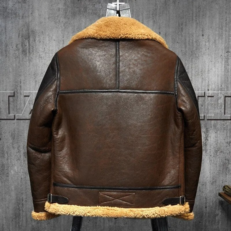 Brown leather jacket with fur lining on a gray textured background