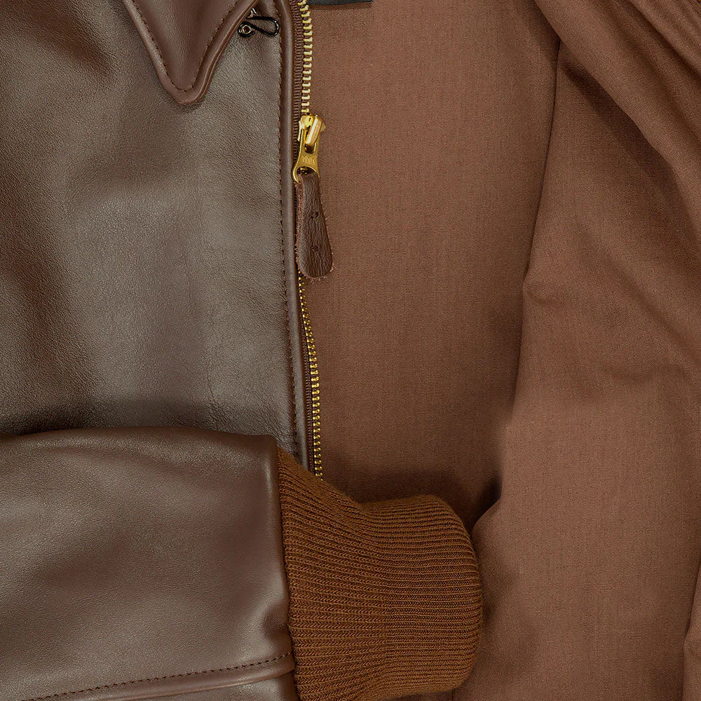 Close-up of a brown leather jacket with a zipper