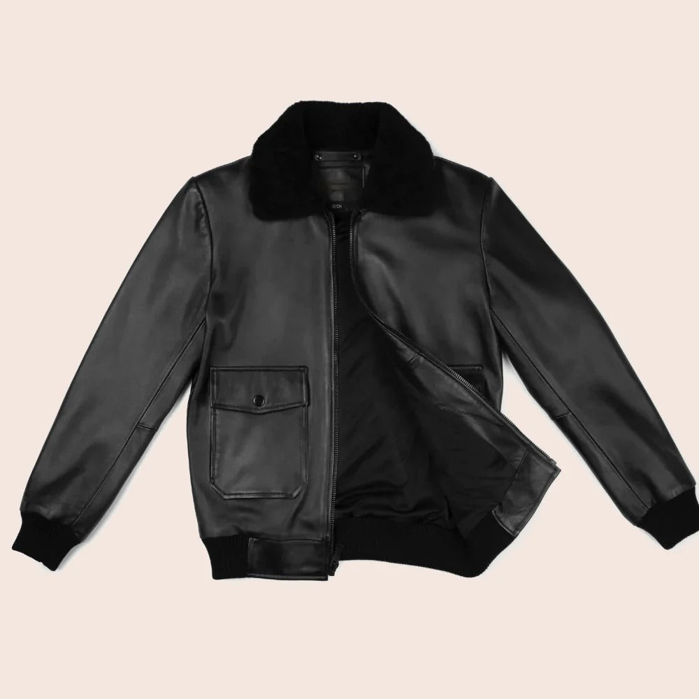 Black leather jacket with fur collar on a beige background