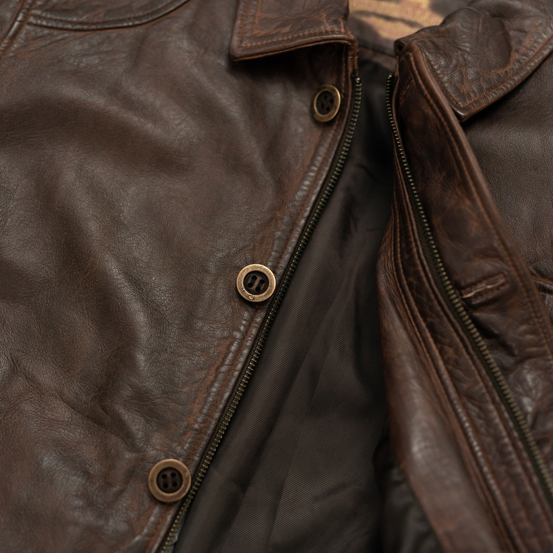 Close-up of a brown leather jacket with buttons and zipper