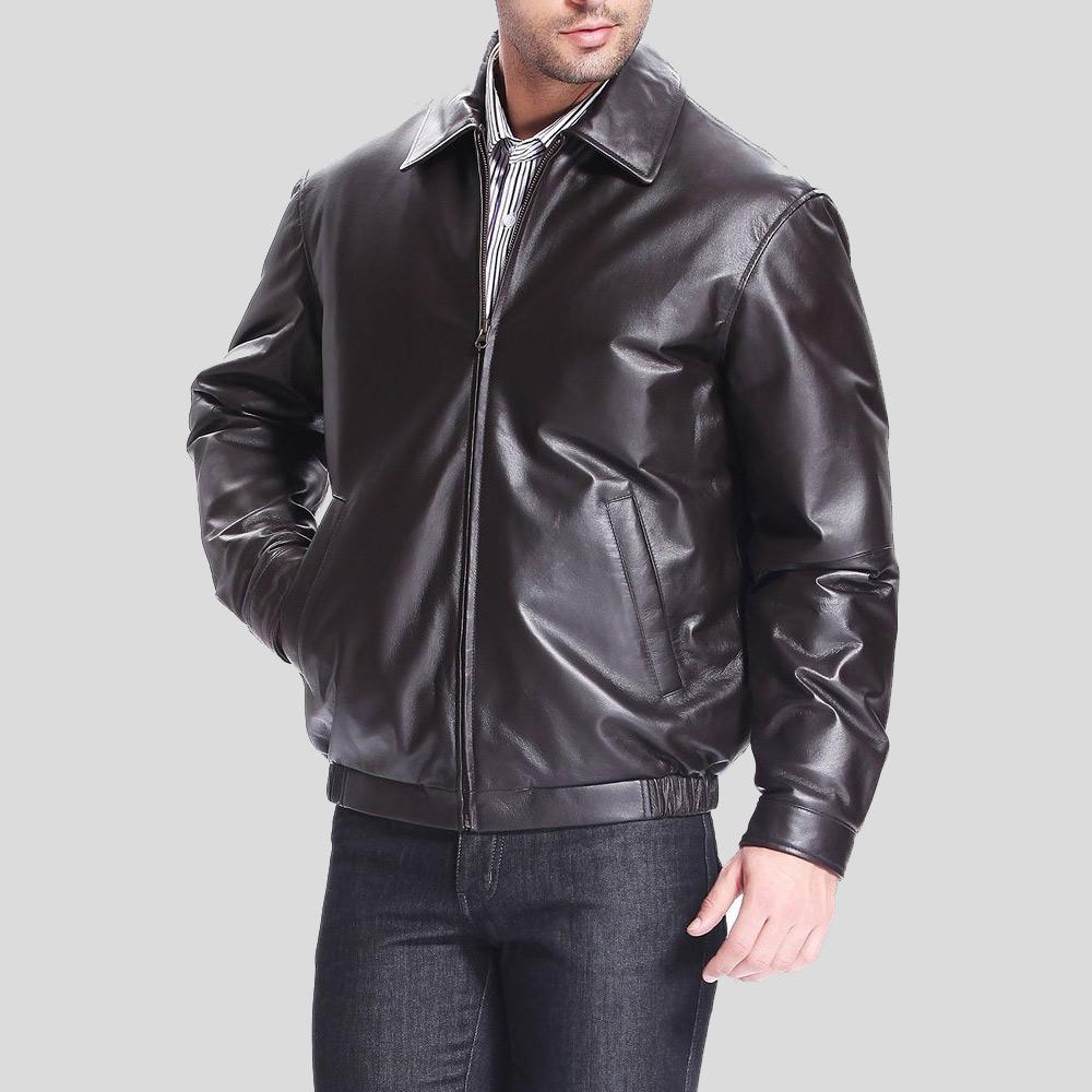 Man wearing a black leather jacket on a gray background