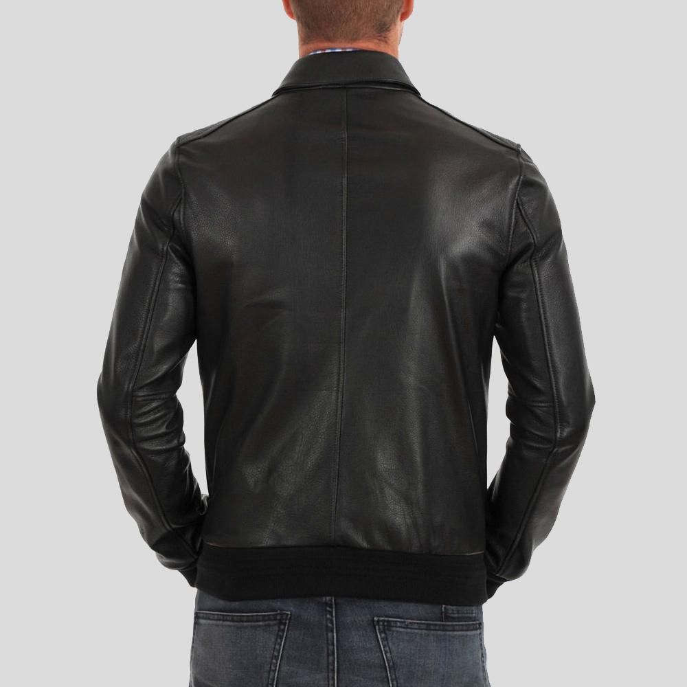 Black leather jacket worn by a person on a gray background
