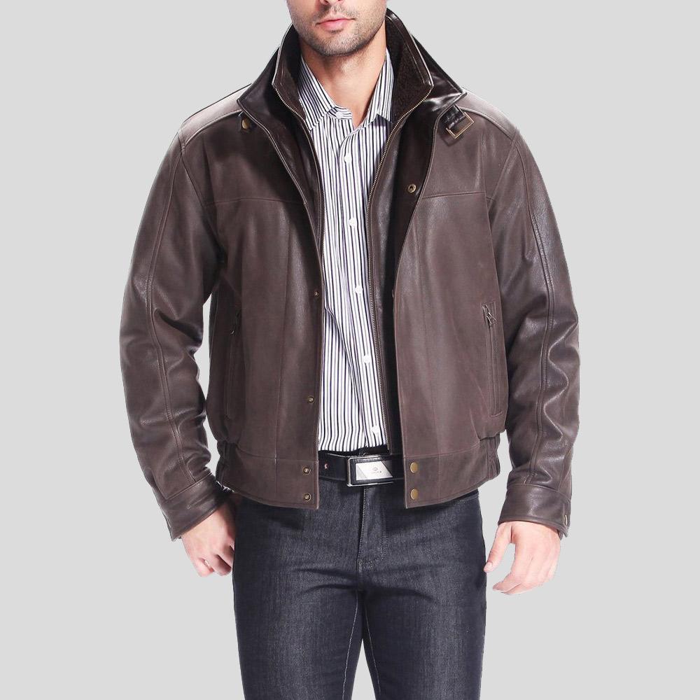 Man wearing a brown leather jacket over a striped shirt on a gray background