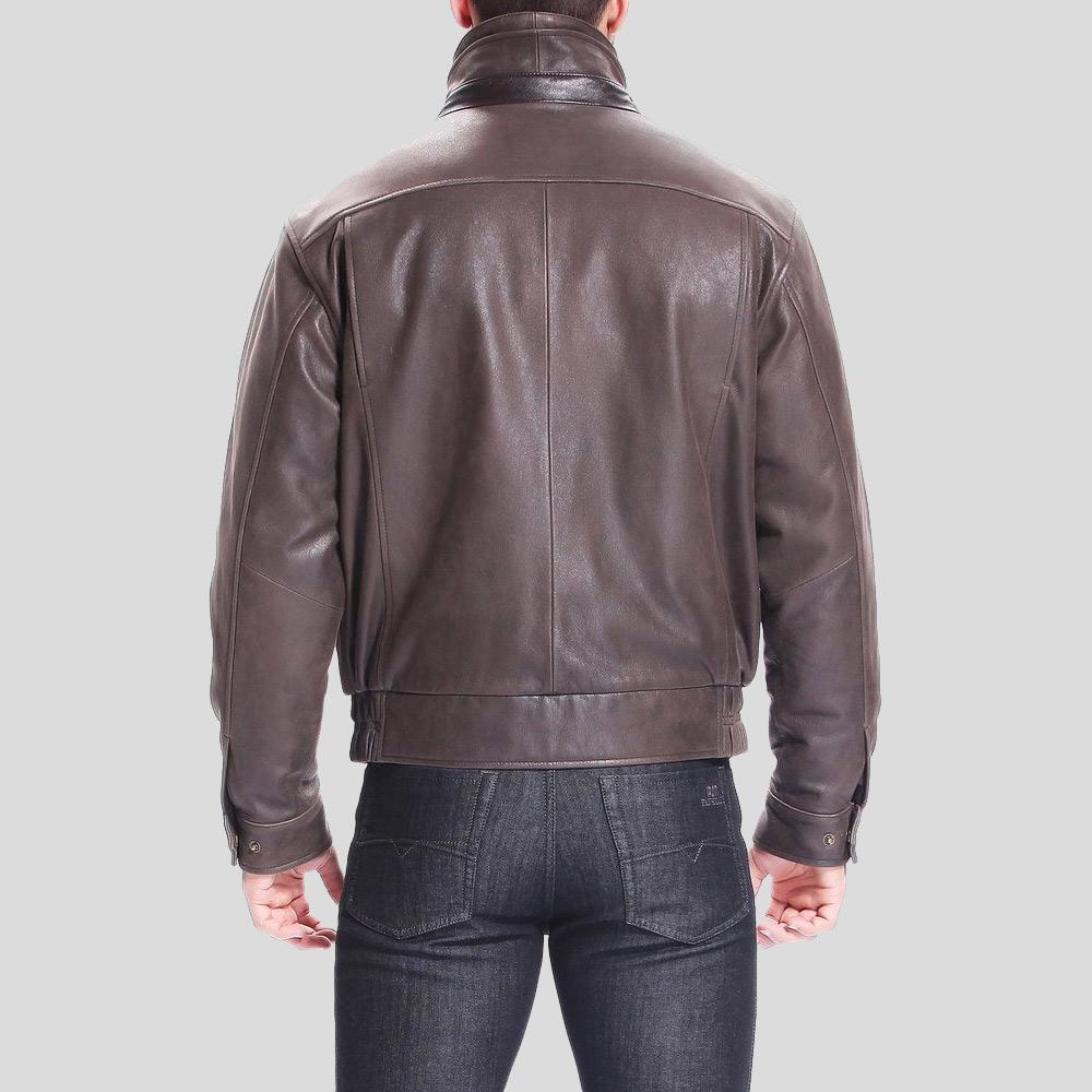 Brown leather jacket worn by a person on a light gray background