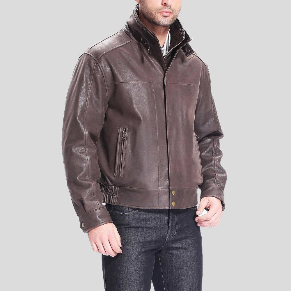 Man wearing a brown leather jacket on a gray background