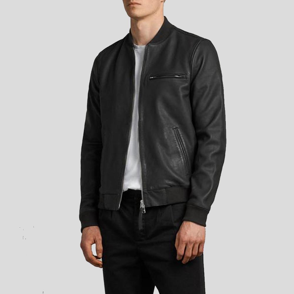 Person wearing a black leather bomber jacket on a light gray background