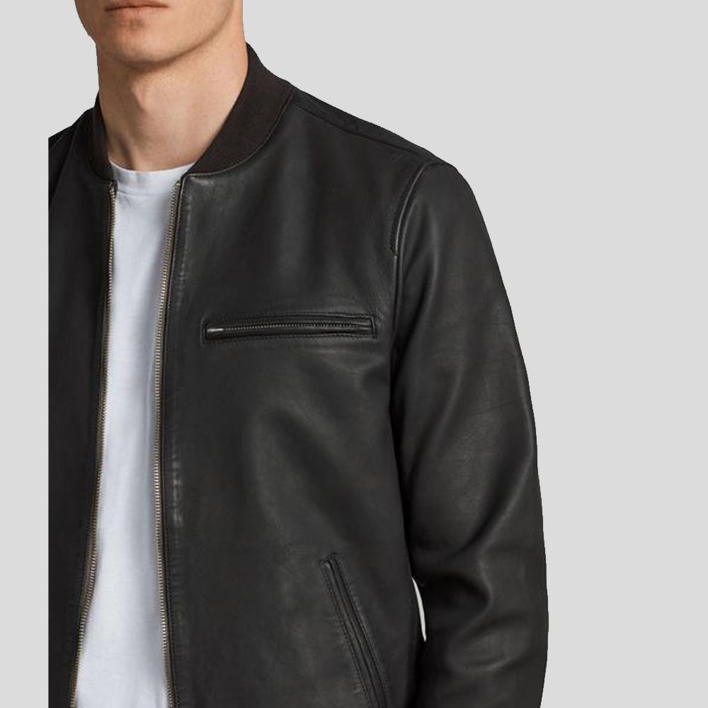 Black leather jacket worn by a person on a light gray background
