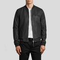 Person wearing a black leather jacket on a light gray background