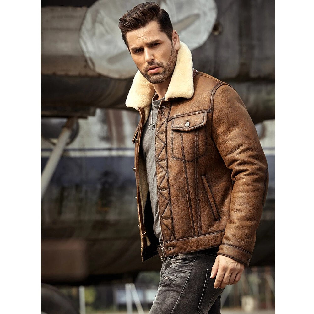 Man wearing a brown leather jacket with a fur-lined collar in an industrial setting.