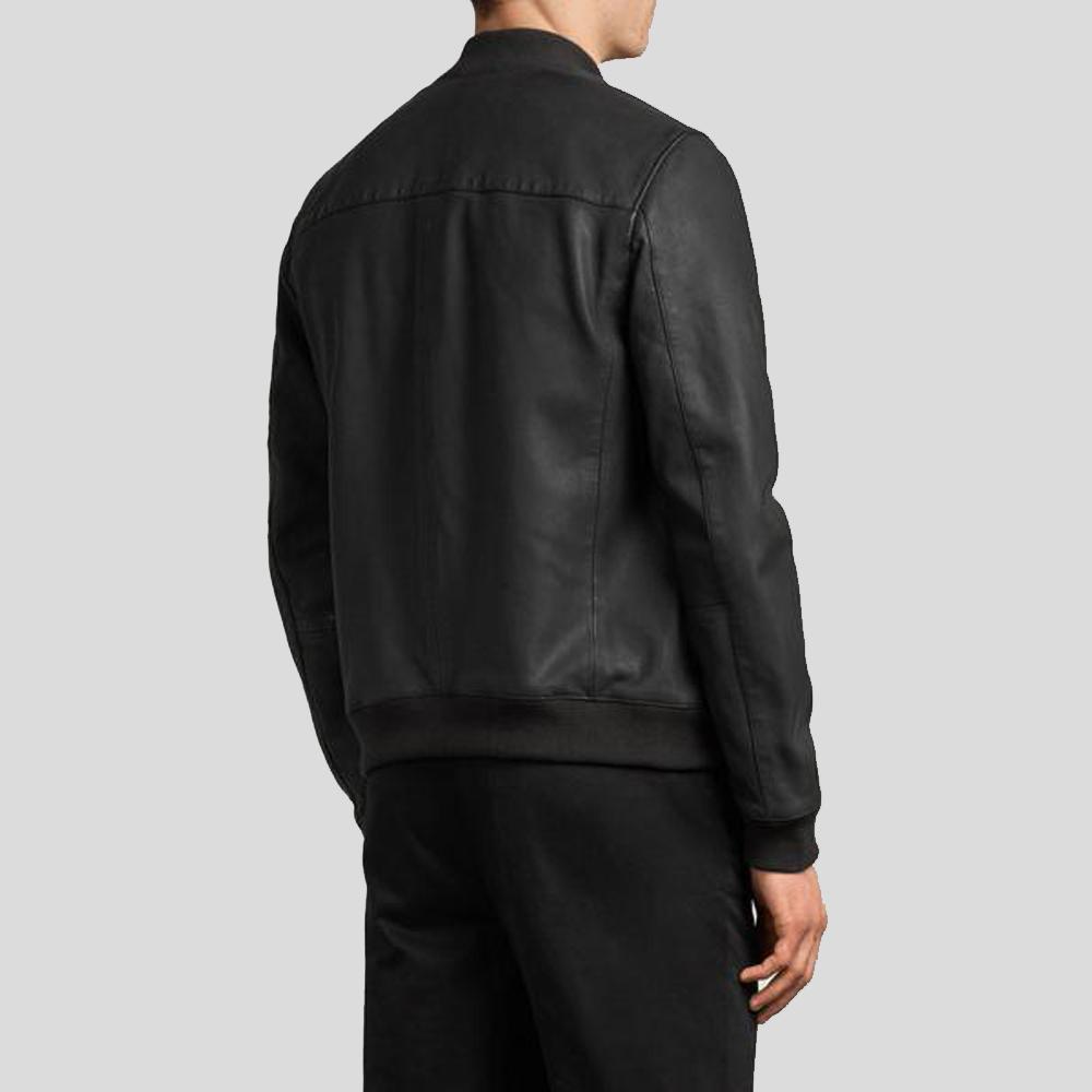 Person wearing a black leather jacket on a light gray background