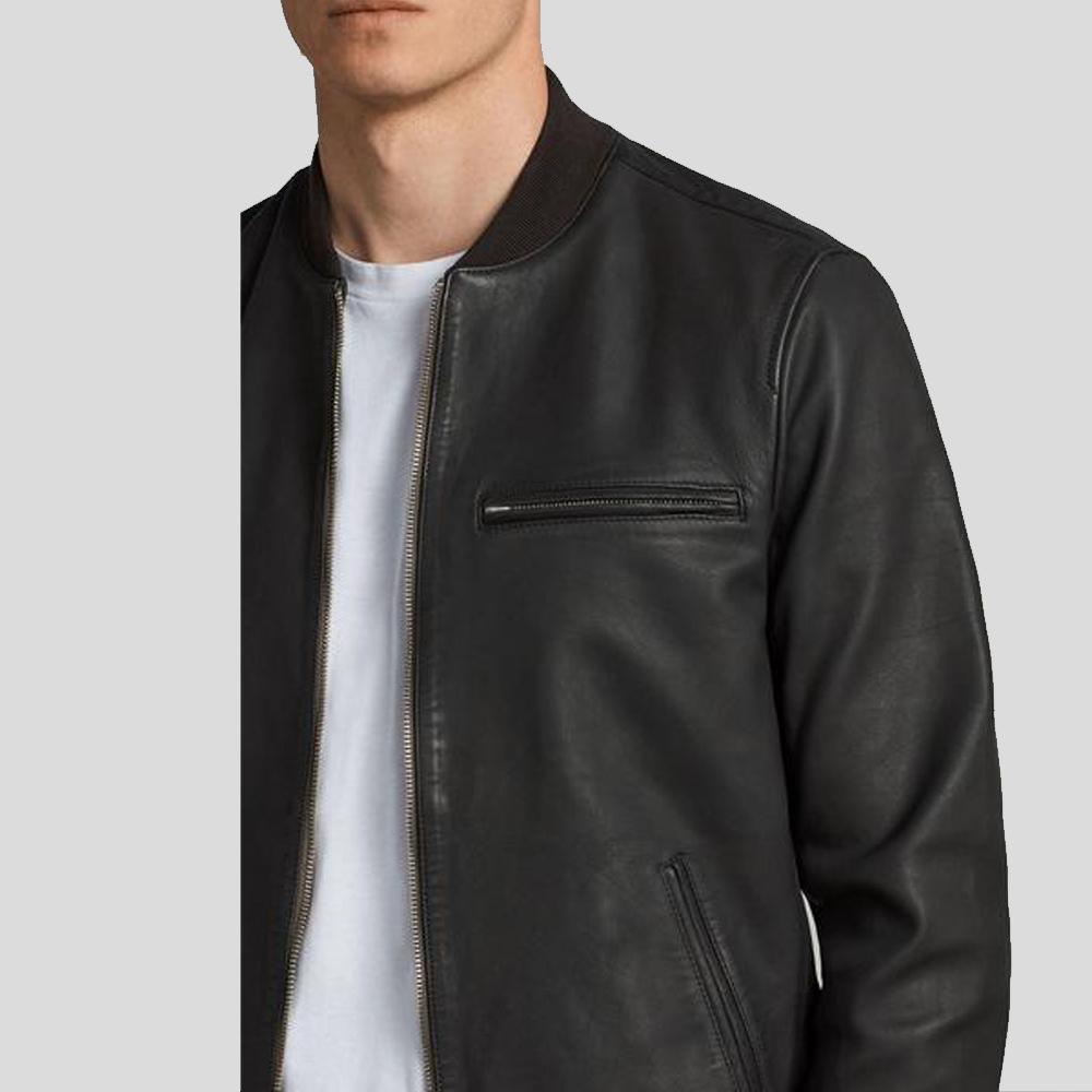 Black leather jacket worn by a person on a light gray background