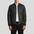 Person wearing a black leather jacket on a light gray background