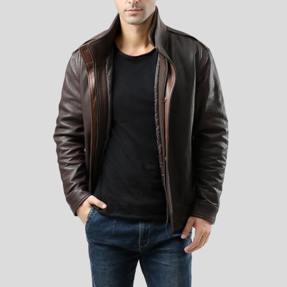 Man wearing a brown leather jacket over a black shirt on a gray background