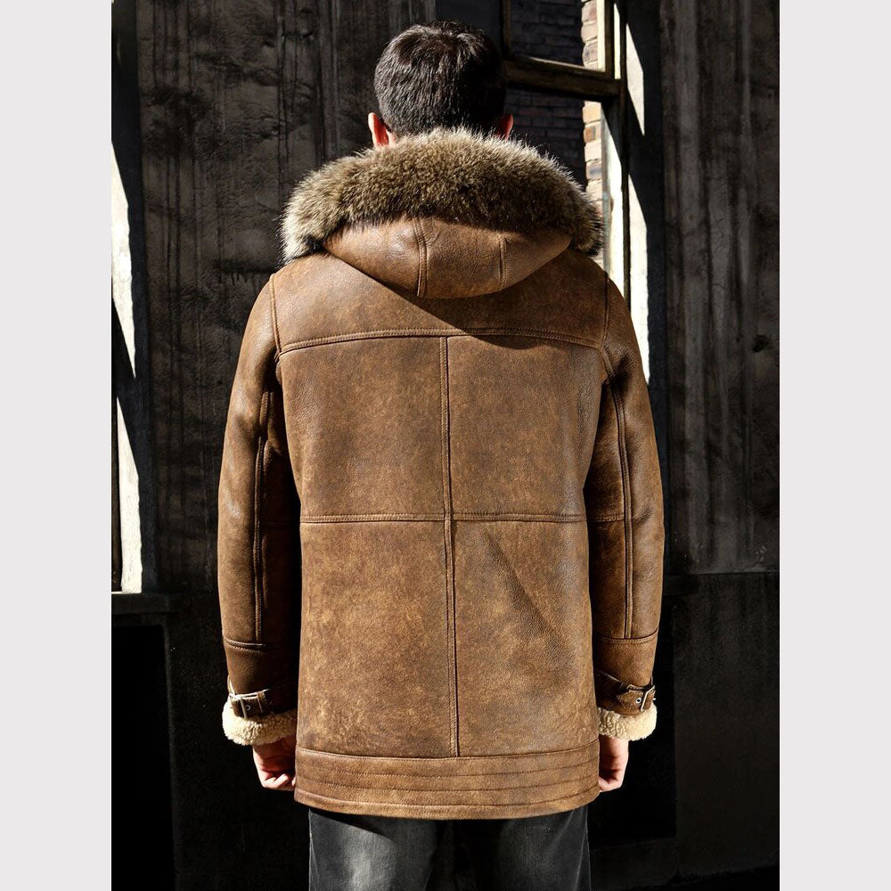 Brown leather coat with fur hood worn by a person in a dark setting