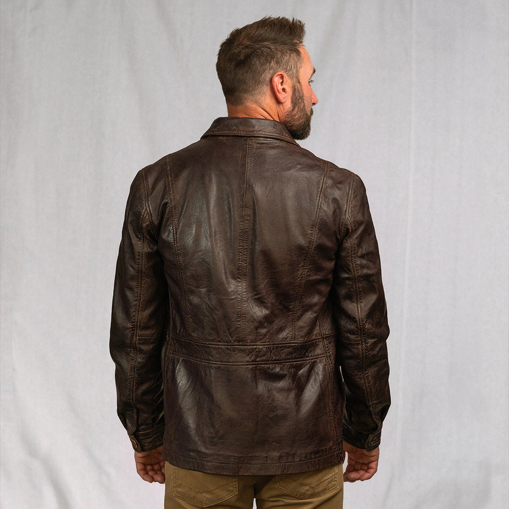 Man wearing a brown leather jacket against a plain background