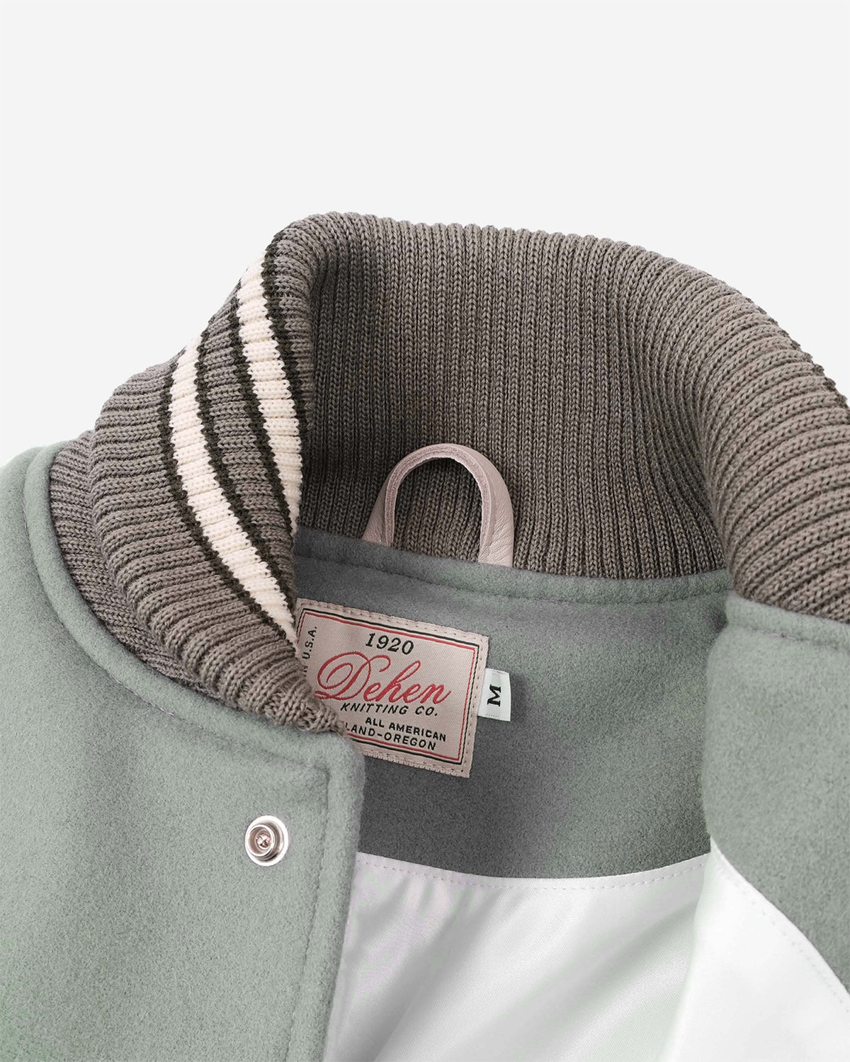 Close-up of a jacket with a brand label on a white background