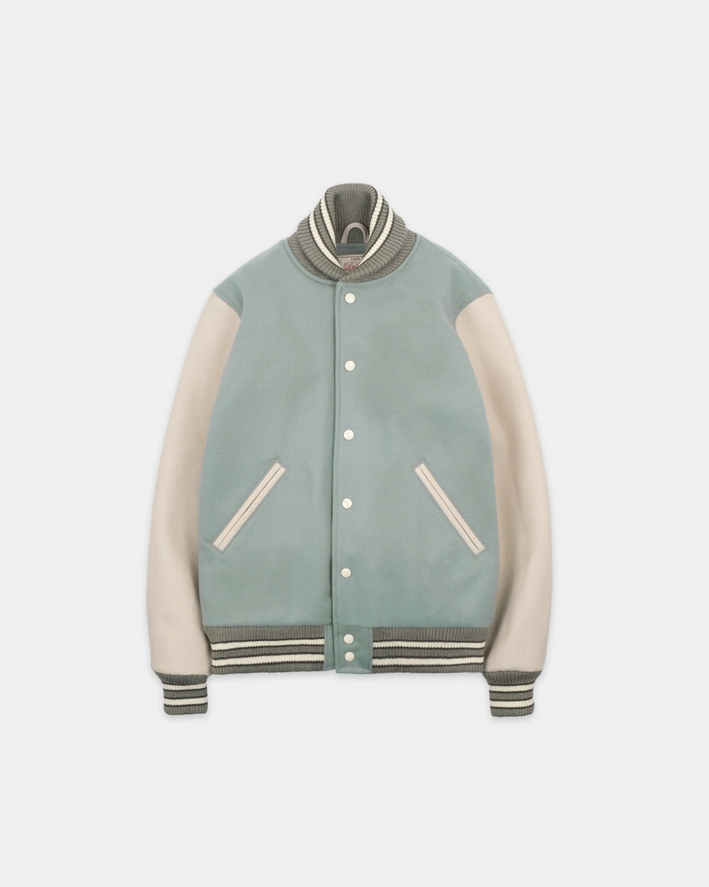 A varsity-style jacket with a muted sage green body, cream-colored sleeves, and striped ribbed collar, cuffs, and hem, displayed against a light gray background.